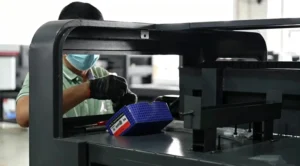 worker assembling laser cutting machine in production workshop